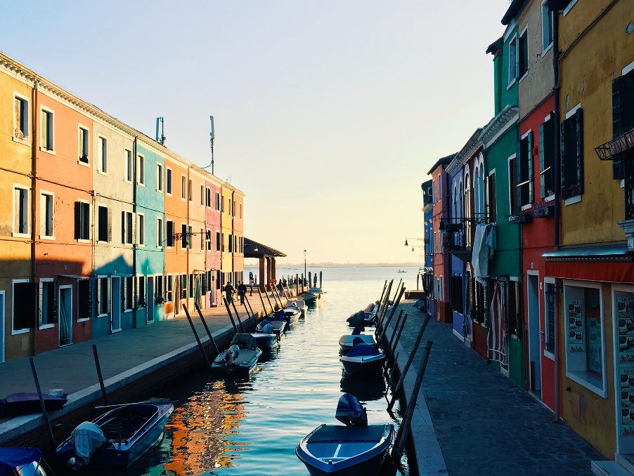 View of canal and colourful buildings with sun light in Italy